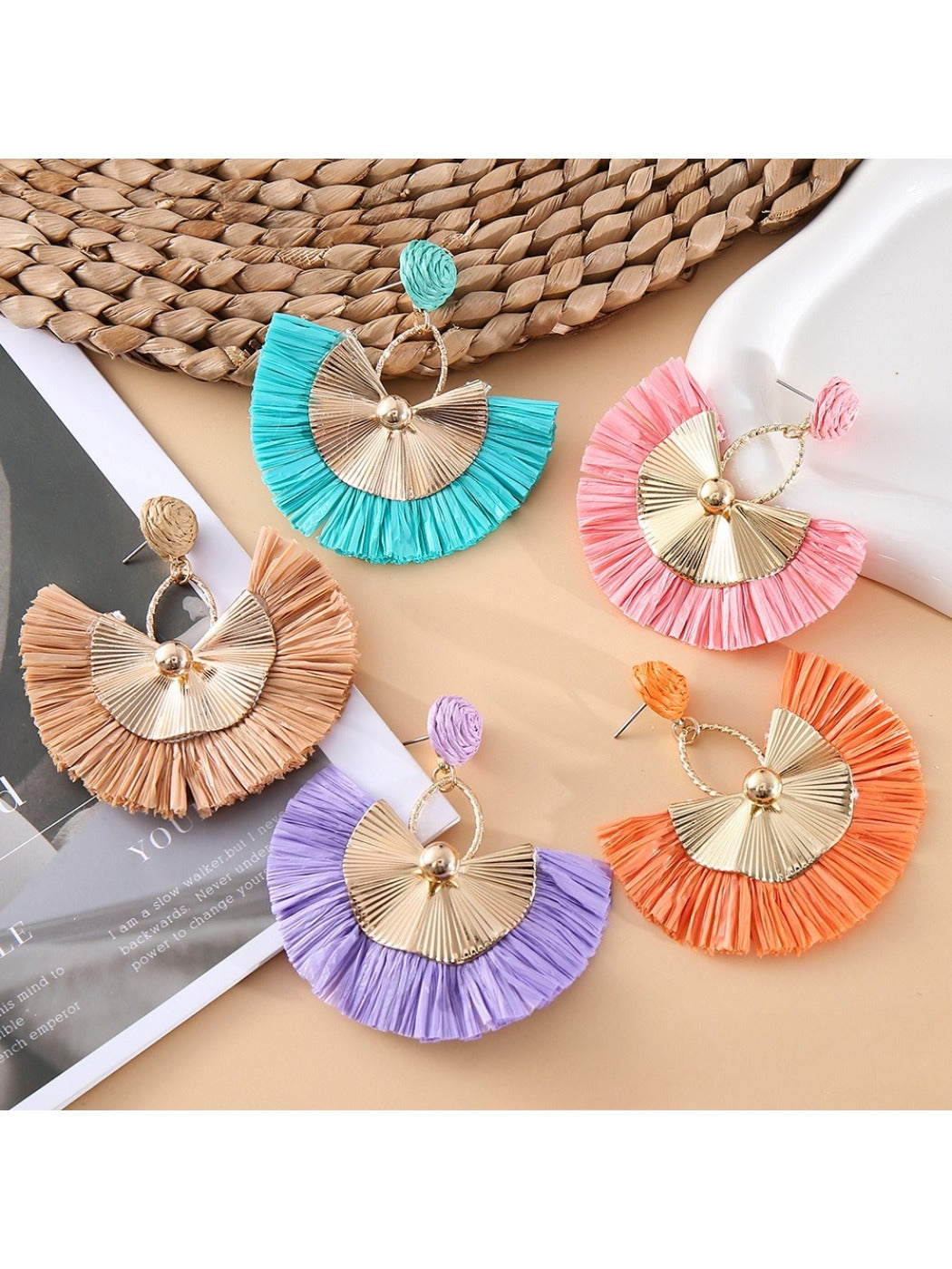 Close-up of Earedge casual style raffia fan earrings on white background