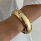 Lovra wide round bangle bracelet worn with casual outfit, emphasizing its versatile style