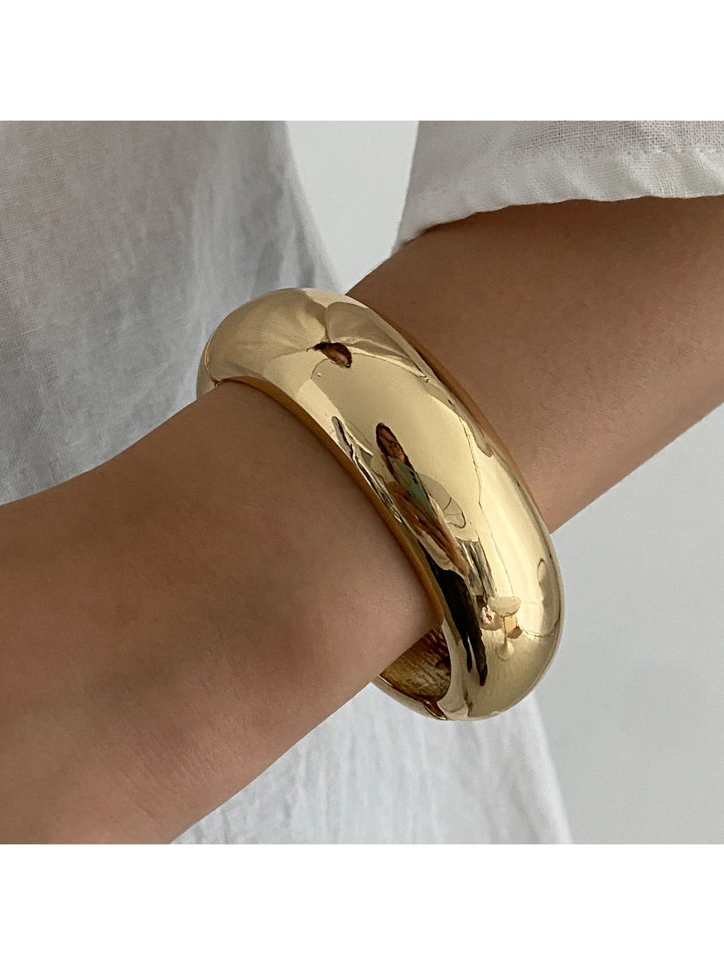 Lovra wide round bangle bracelet worn with casual outfit, emphasizing its versatile style