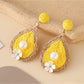 Earedge chic teardrop drop earrings photographed with soft shadows