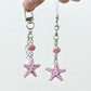 Starfish pendant keychain with a silver keyring on a white background