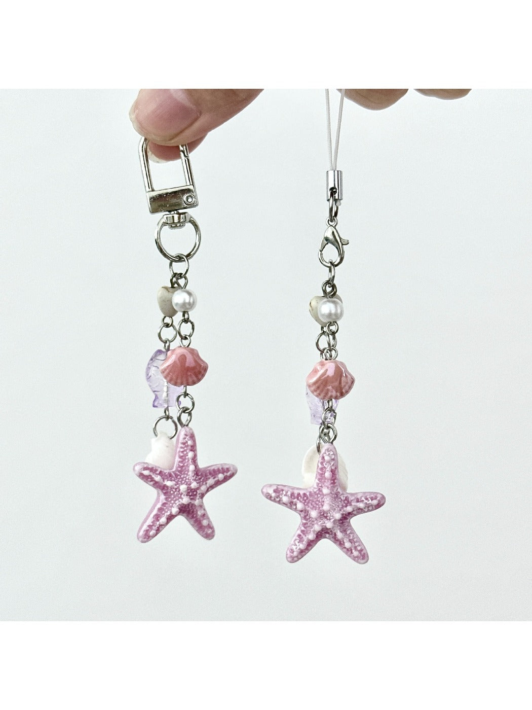 Starfish pendant keychain with a silver keyring on a white background