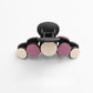 Beau hair clip paired with other hair accessories on a vanity