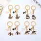Close-up of cartoon cat face on piano keychain with smiling expression