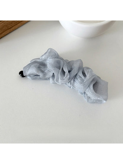 Beau tulle ruffle high ponytail claw clip shown from above on a flat surface