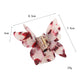Side view of pastel pink butterfly claw clip with open claws