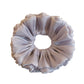 Purple tulle scrunchie with reflective sheen displayed on a white background