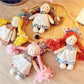 Front view of Keypus cartoon doll bag charm keychain with colorful outfit and smiling face