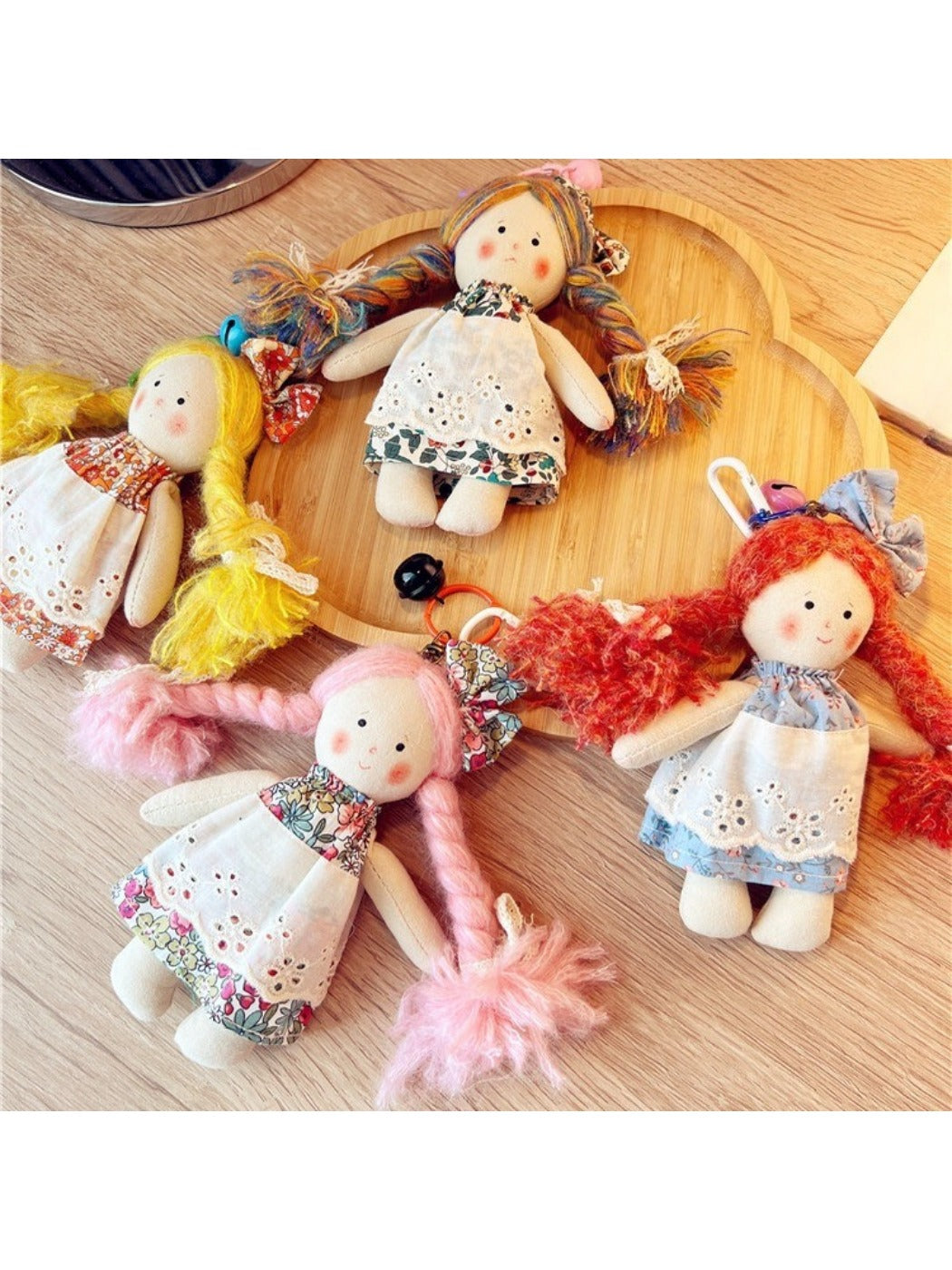 Front view of Keypus cartoon doll bag charm keychain with colorful outfit and smiling face