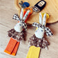 Fabric rabbit keychain attached to a set of keys on a wooden surface