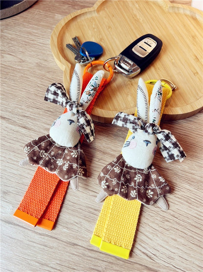 Fabric rabbit keychain attached to a set of keys on a wooden surface