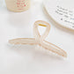 Model wearing Beau square crisscross hair claw clip with loose waves