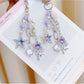 Purple star-shaped flower charm on a silver keyring keychain