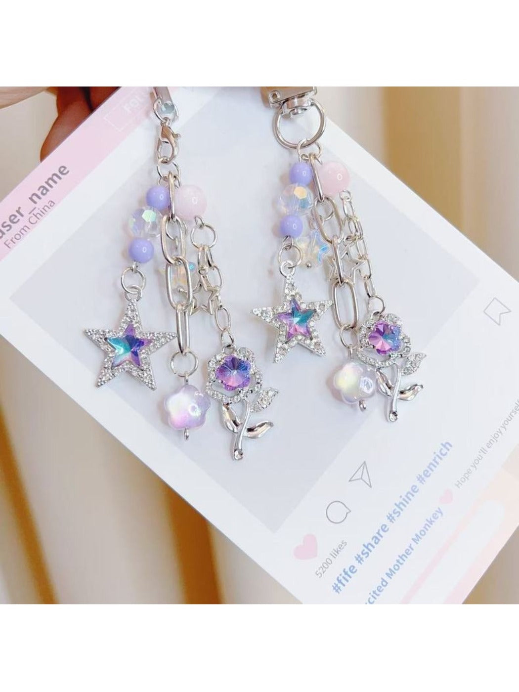 Purple star-shaped flower charm on a silver keyring keychain
