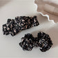 Beau bow hair clip displayed on white background highlighting floral design