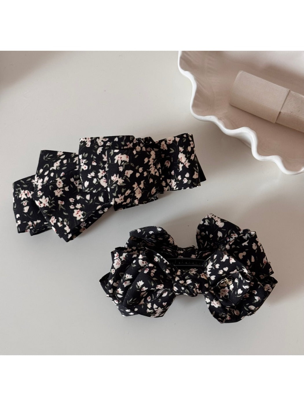 Beau bow hair clip displayed on white background highlighting floral design