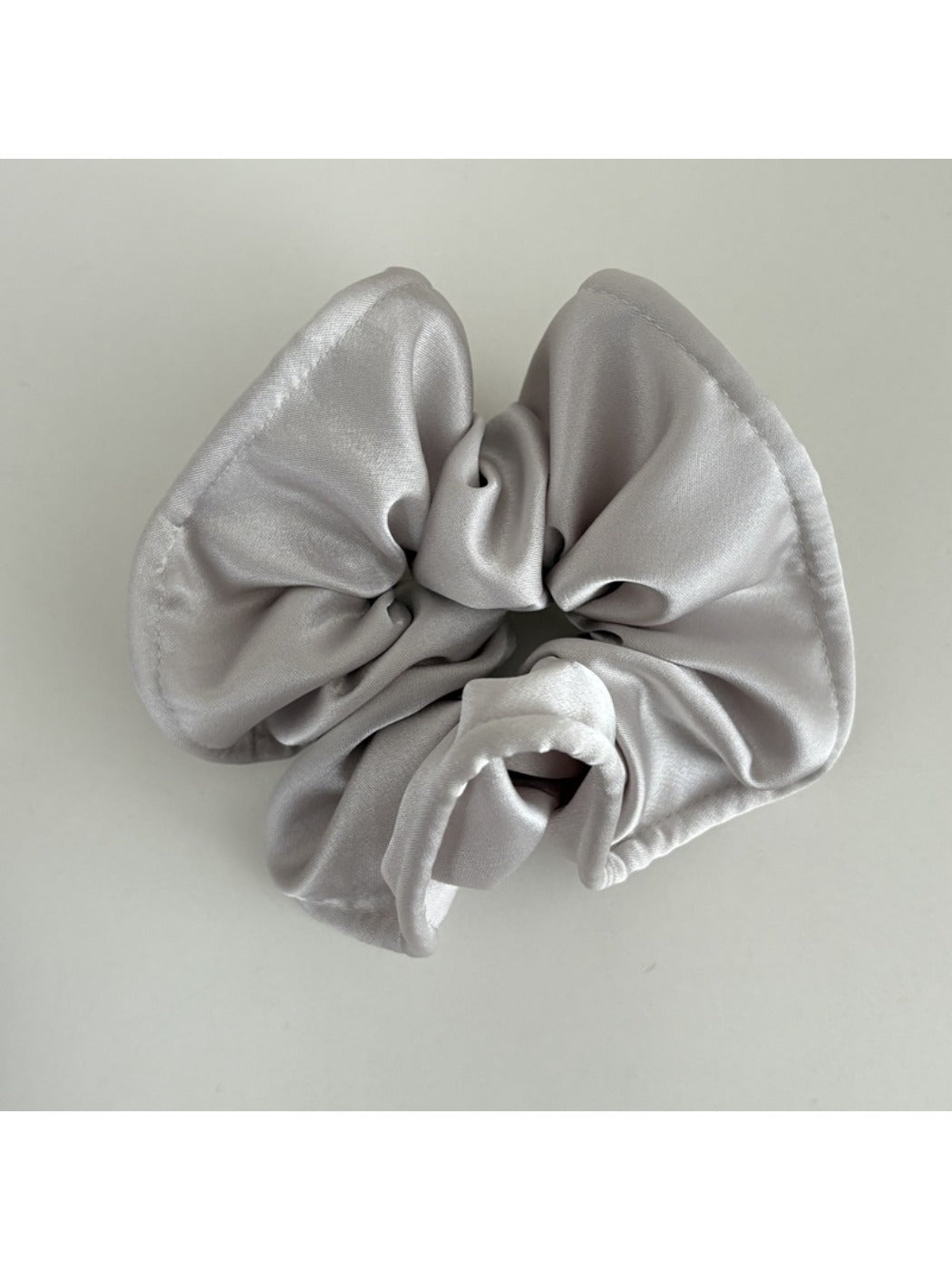 Gifty satin finish silky scrunchie folded neatly on a light-colored surface