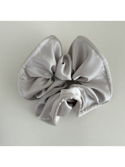 Gifty satin finish silky scrunchie folded neatly on a light-colored surface