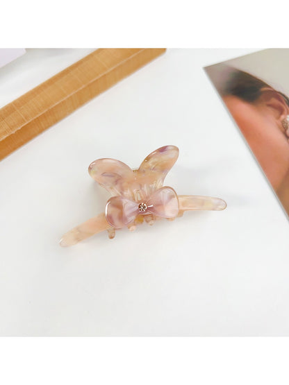 Close-up of bow detail on Beau hair claw clip showing smooth edges