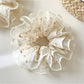Gifty tulle ruffle scrunchie with pink and white floral print on sheer fabric