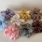 Close-up of soft fabric scrunchie showing texture and floral design