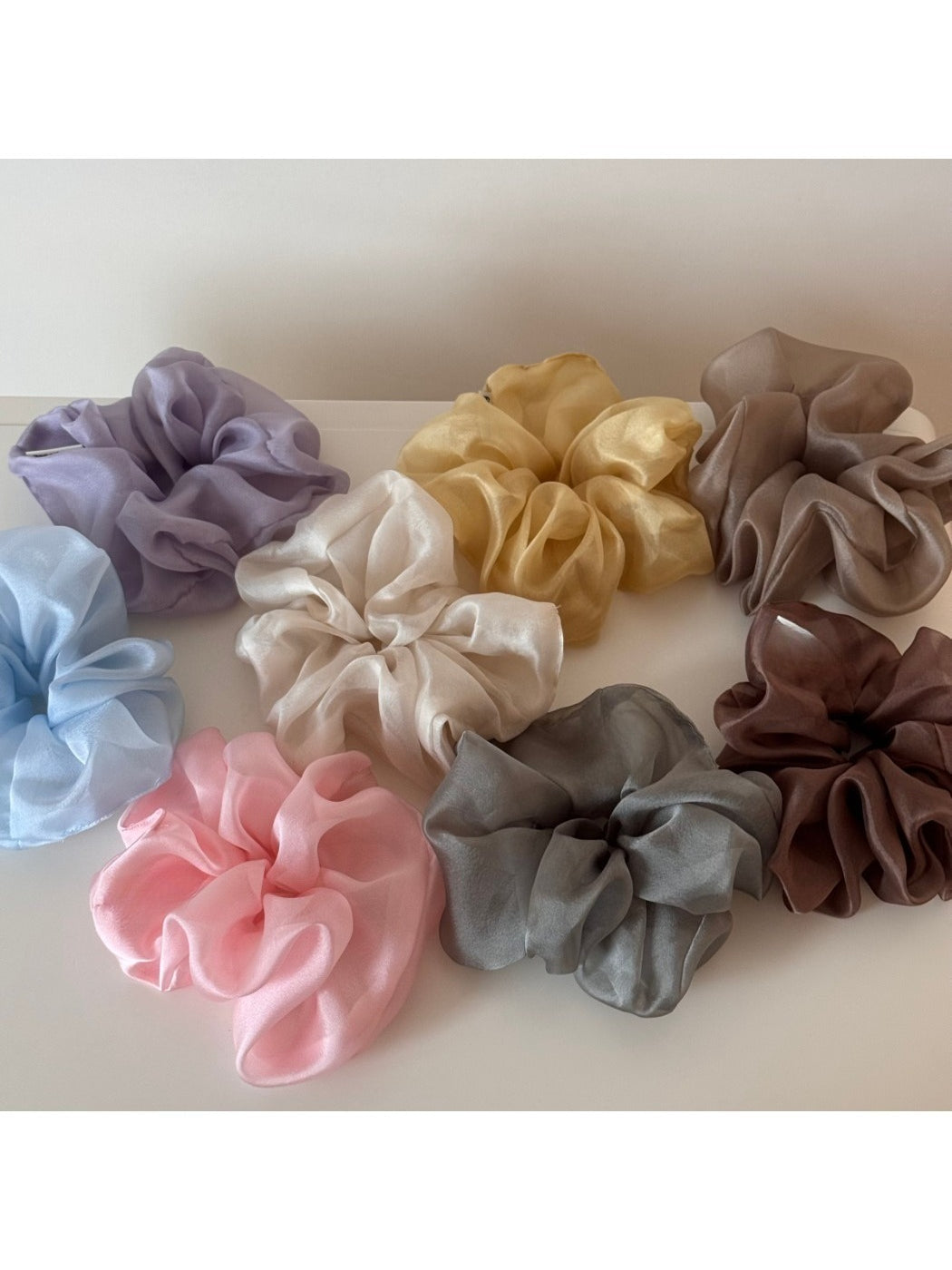 Close-up of soft fabric scrunchie showing texture and floral design