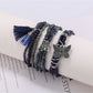 Beaded bracelet with butterfly pendant displayed on a white background