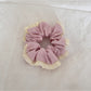 Gifty tulle scrunchie worn on a wrist, highlighting soft ruffled fabric