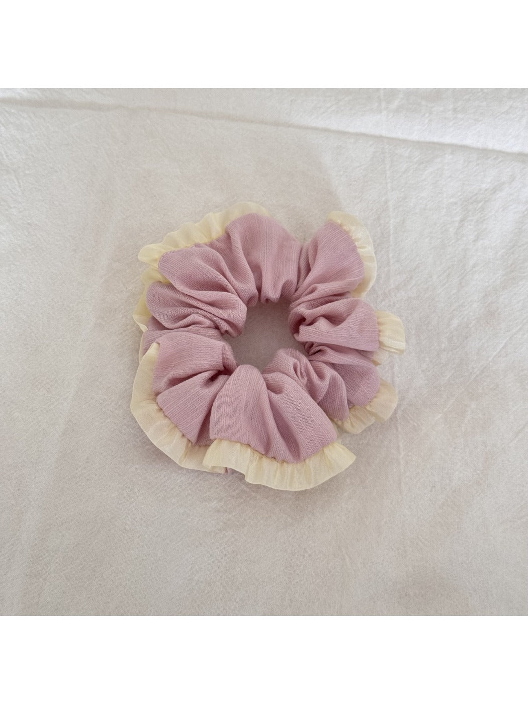 Gifty tulle scrunchie worn on a wrist, highlighting soft ruffled fabric