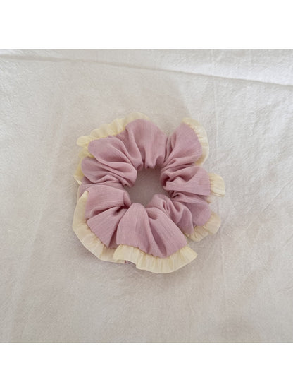 Gifty tulle scrunchie worn on a wrist, highlighting soft ruffled fabric