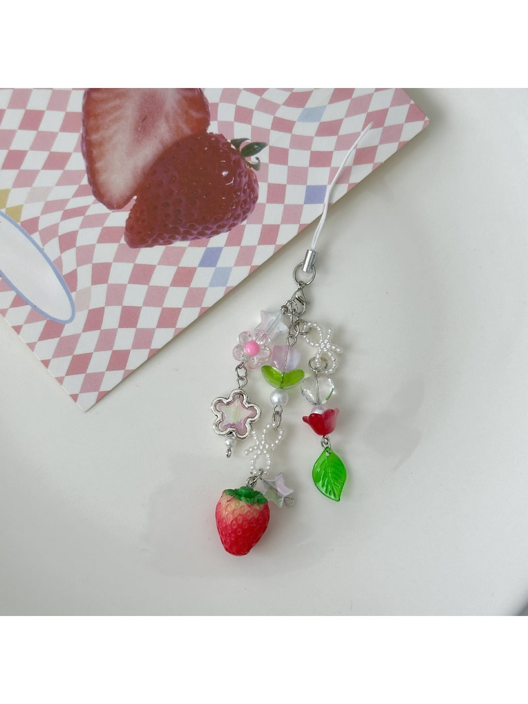 Sweet Tulip Strawberry keychain displayed hanging against a white background