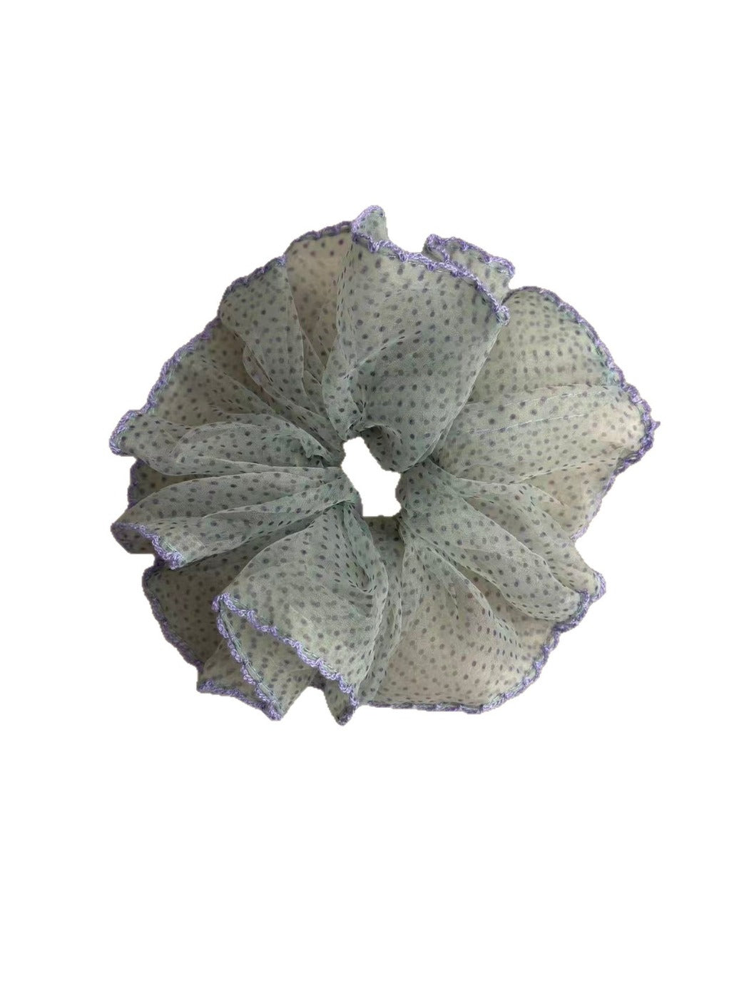 Close-up of purple polka dot scrunchie showing fabric texture and trim detail