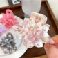 Close-up of beige lotus shaped hair claw clip showing curved petals design