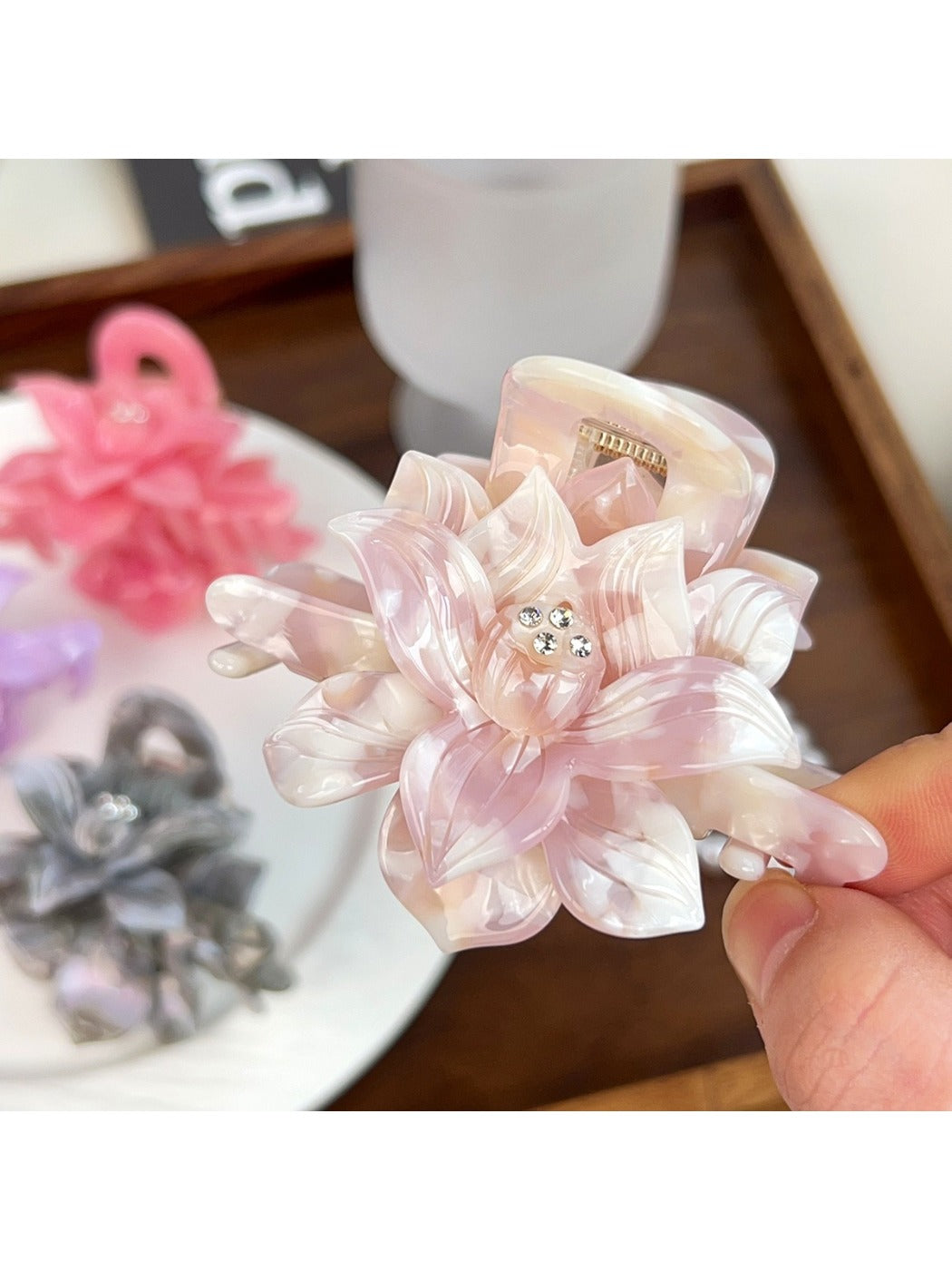 Close-up of beige lotus shaped hair claw clip showing curved petals design