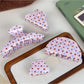 Side view of Beau crescent pink claw clip with white polka dots highlighting clip teeth