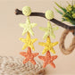 Detailed shot of star pendant and chain on Earedge earrings