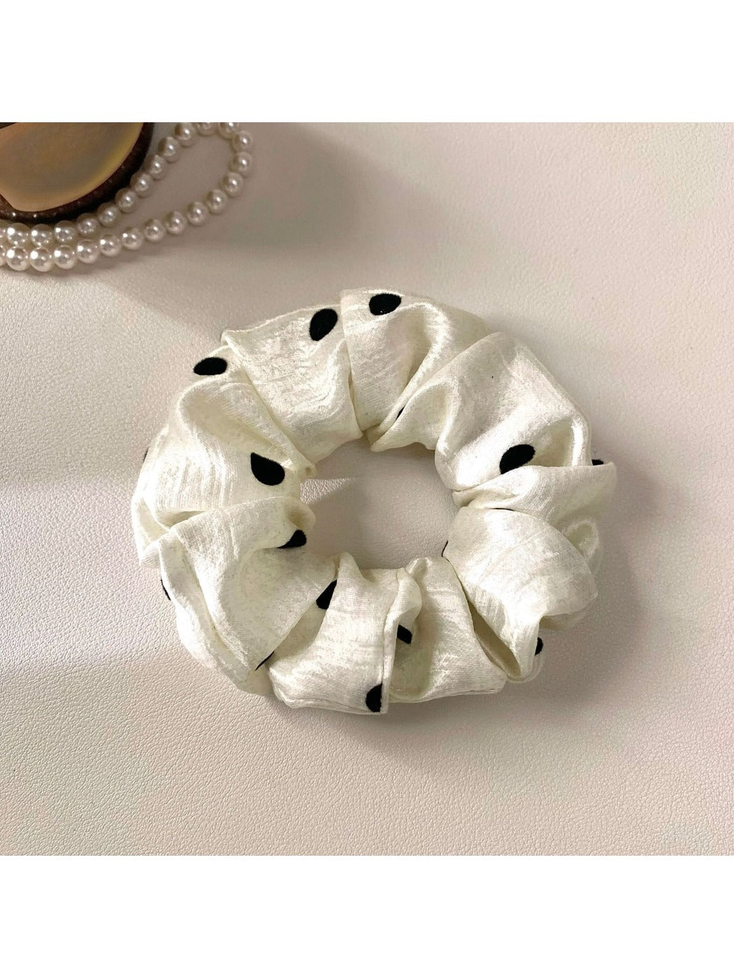 Gifty satin polka dot scrunchie neatly folded to highlight smooth satin material