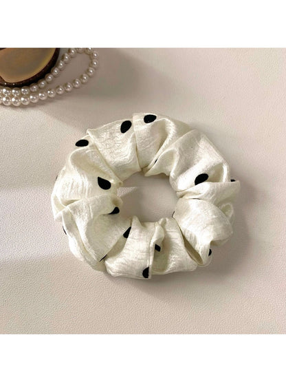 Gifty satin polka dot scrunchie neatly folded to highlight smooth satin material