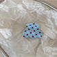 Beau blue polka dot hair clip packaged in clear plastic