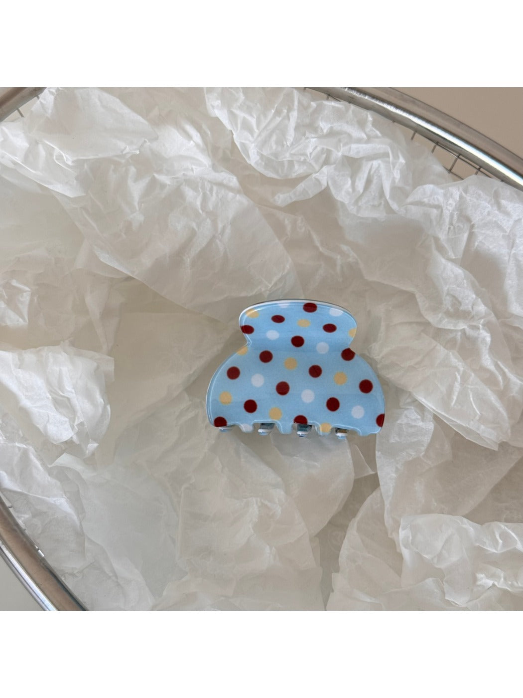 Beau blue polka dot hair clip packaged in clear plastic