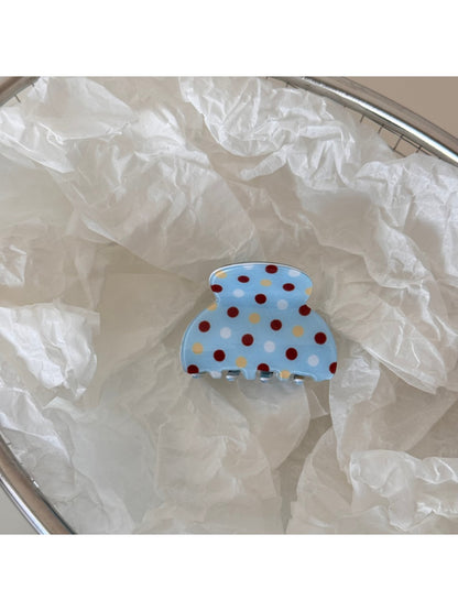 Beau blue polka dot hair clip packaged in clear plastic