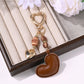 Close-up of brown leather heart keychain showing texture and stitching