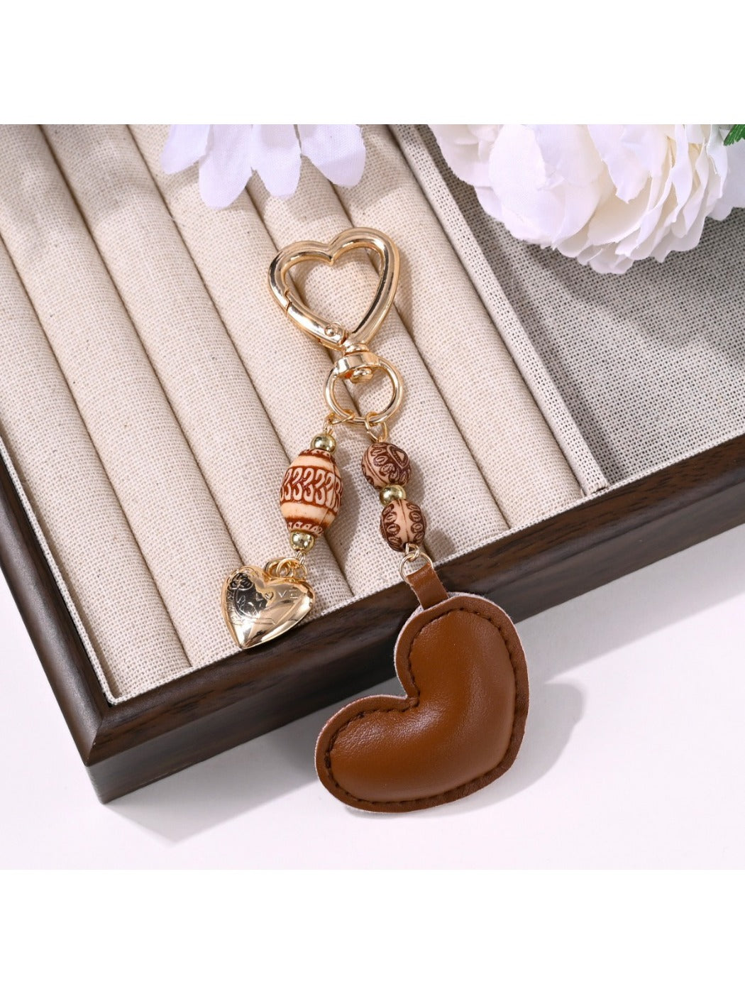 Close-up of brown leather heart keychain showing texture and stitching