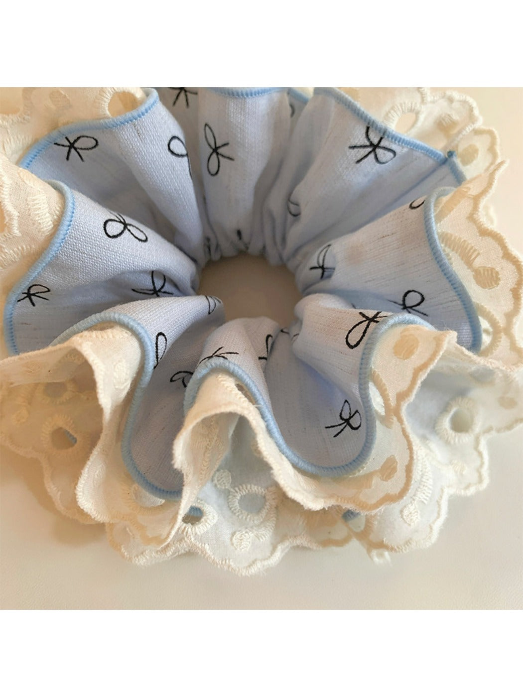 Model wearing Gifty bow print ruffled scrunchie in her hair, styled in a ponytail