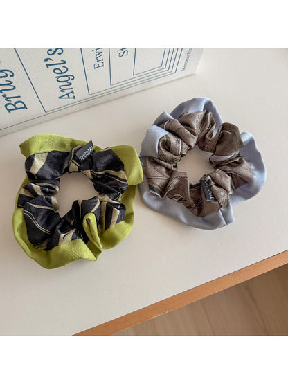 Gifty scrunchie displayed on a white background showing its vibrant color block pattern