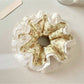 Close-up of Gifty vintage floral ruched scrunchie with pink and green flower pattern