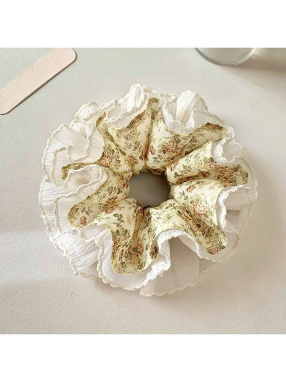 Close-up of Gifty vintage floral ruched scrunchie with pink and green flower pattern