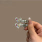 Set of colorful modern minimalist hair clips arranged on a white surface