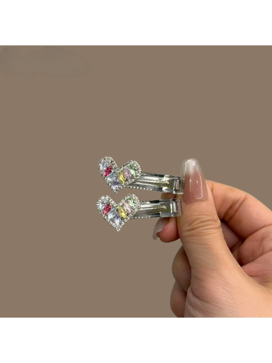Set of colorful modern minimalist hair clips arranged on a white surface