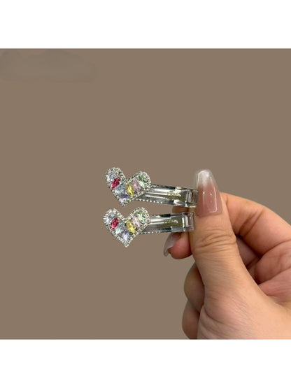 Set of colorful modern minimalist hair clips arranged on a white surface